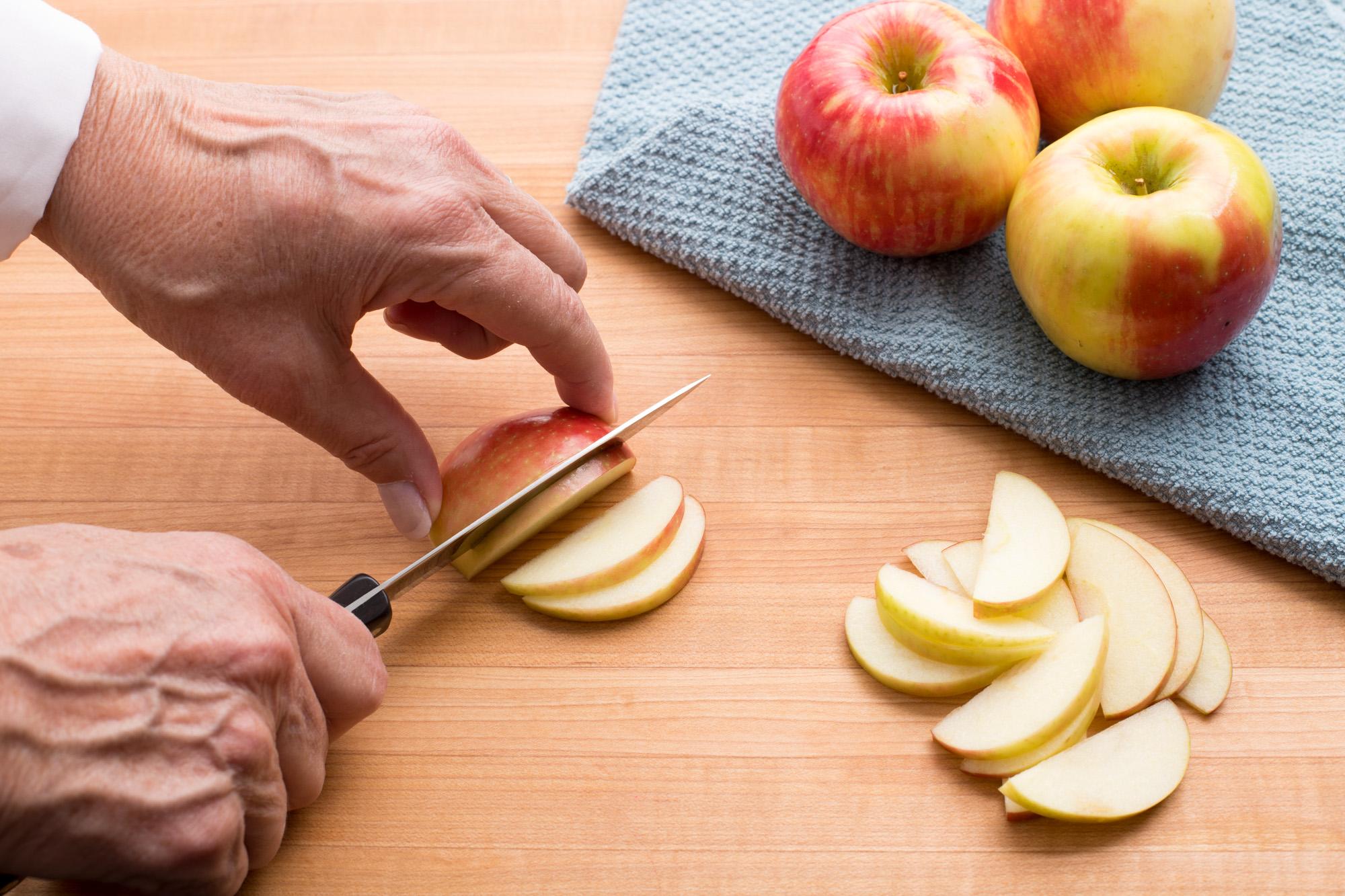 knife slicing apple