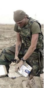 soldier opening mail with knife