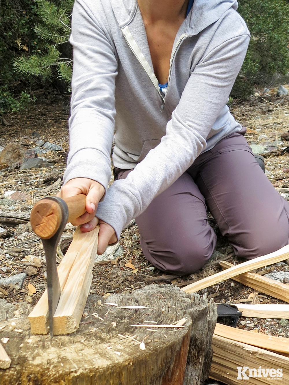 The safest most efficient way of splitting wood is by bringing the wood and the tomahawk down together, driving the bit into the wood to create a split, and then pulling them apart. This student was practicing her skills during a Randall’s Adventure &amp; Training survival class in California. 