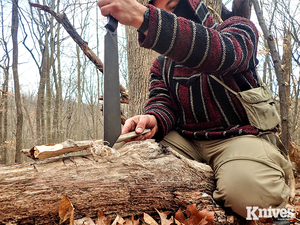 The author makes his tinder and kindling shavings for a fire by pounding the tip of the knife securely in a log and drawing split wood back against the blade.