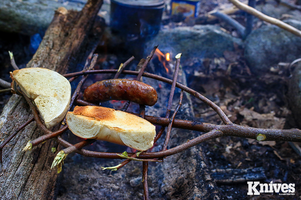 A temporary hand grill is easily made with a knife and some ingenuity.