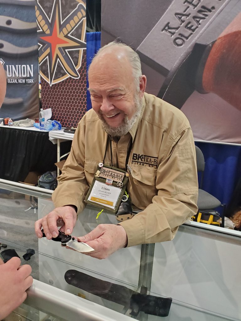 Ethan Becker demonstrates his new Becker Knife &amp; Tool folder at the KA-BAR booth.