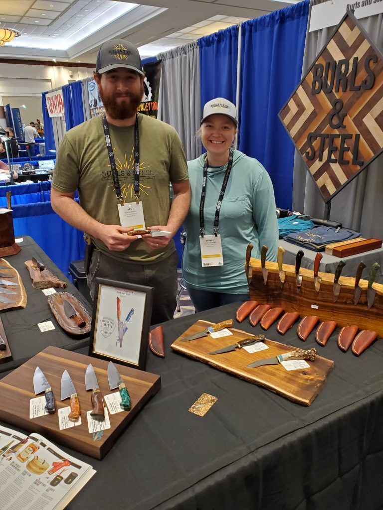 Ben and Sydney Spurrier of Burls and Steel with their 2021 Blade Show display.