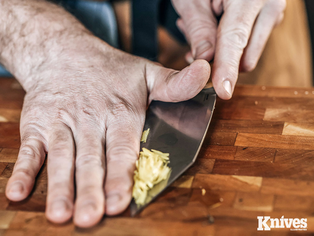 The wide blade of the Station Knife serves well as an improvised spatula for scooping ingredients from the cutting board to the pan.