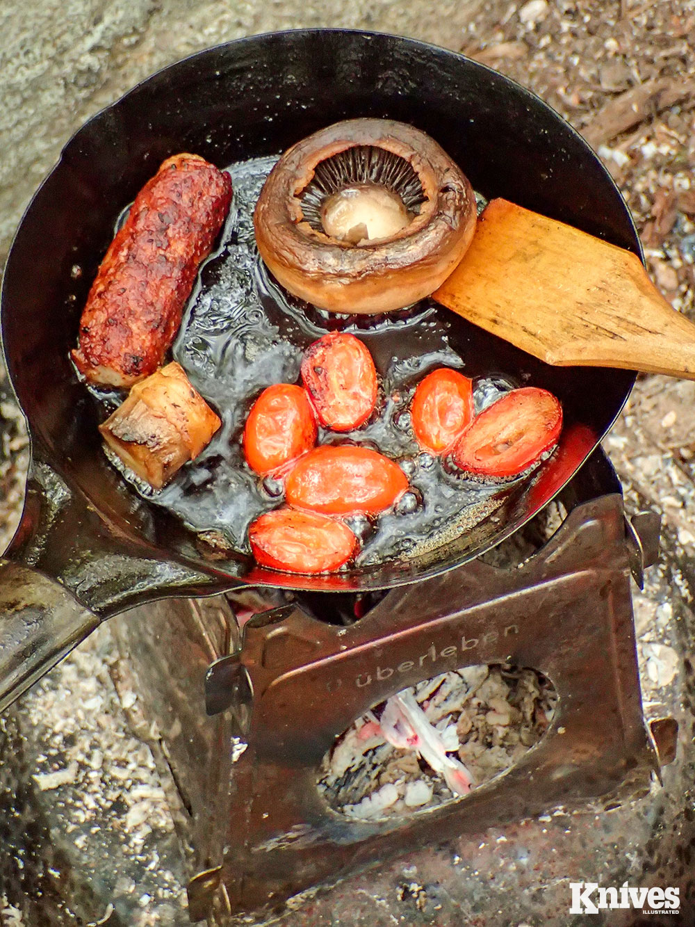 Fresh back from Scotland, the author made the equivalent of a half-Scottish breakfast in the woods (minus the blood sausage). Mini-camp skillet (carbon steel), hand-carved spatula, all-purpose seasoning, a good knife, and coffee all played a role. There is no reason to make camp cooking boring or mundane with a theme like this.