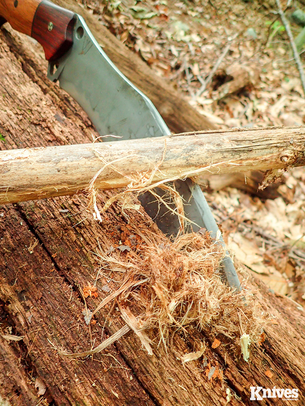 A common way to slice food with a khukuri knife in Nepal is to prop it against the body.