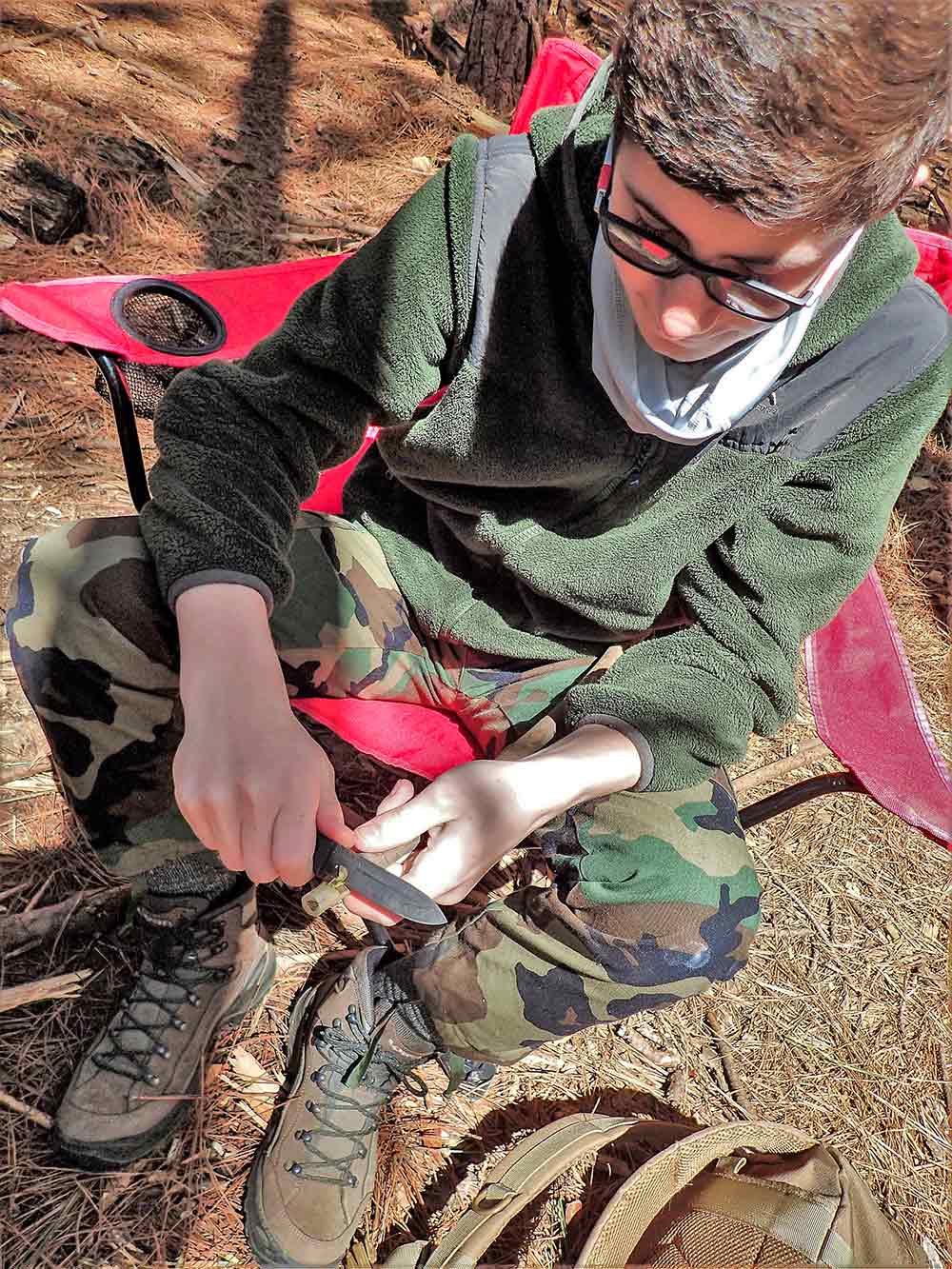 A student safely uses his knife