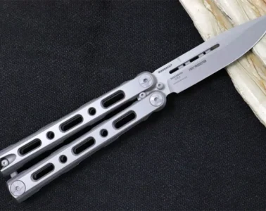 A stainless steel butterfly knife from Benchmade, with a skeletonized handle and drop-point blade.